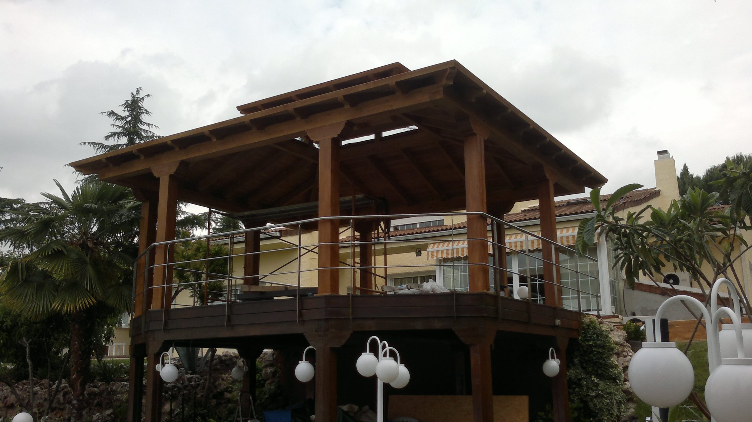 Cenador de madera elevado con cubierta y barandilla